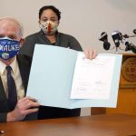 Healing a racial division: Mayor Tom Barrett signs ordnance extending MLK Drive into downtown