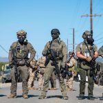 U.S. historians say the visuals of masked ICE agents detaining workers match Klan era tactics