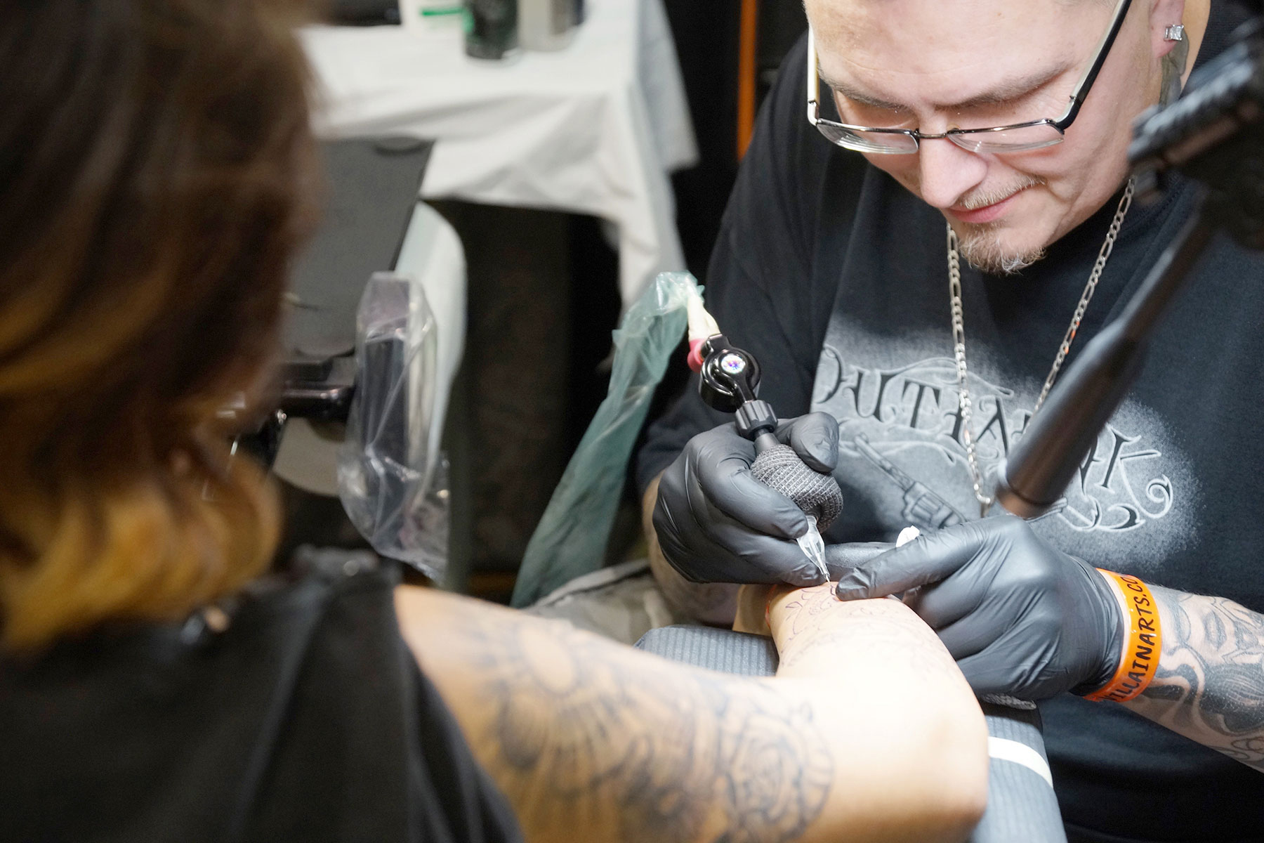 Art collectors get colorful body modifications with tattoos at annual