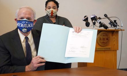 Healing a racial division: Mayor Tom Barrett signs ordnance extending MLK Drive into downtown